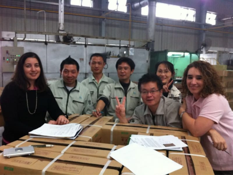 Carolina Baffigo with a manufacturing team at a factory